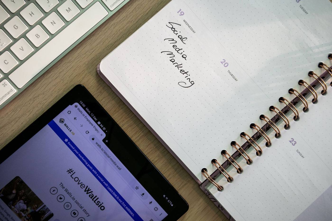Social media manager planning a content calendar on a tablet, at a desk