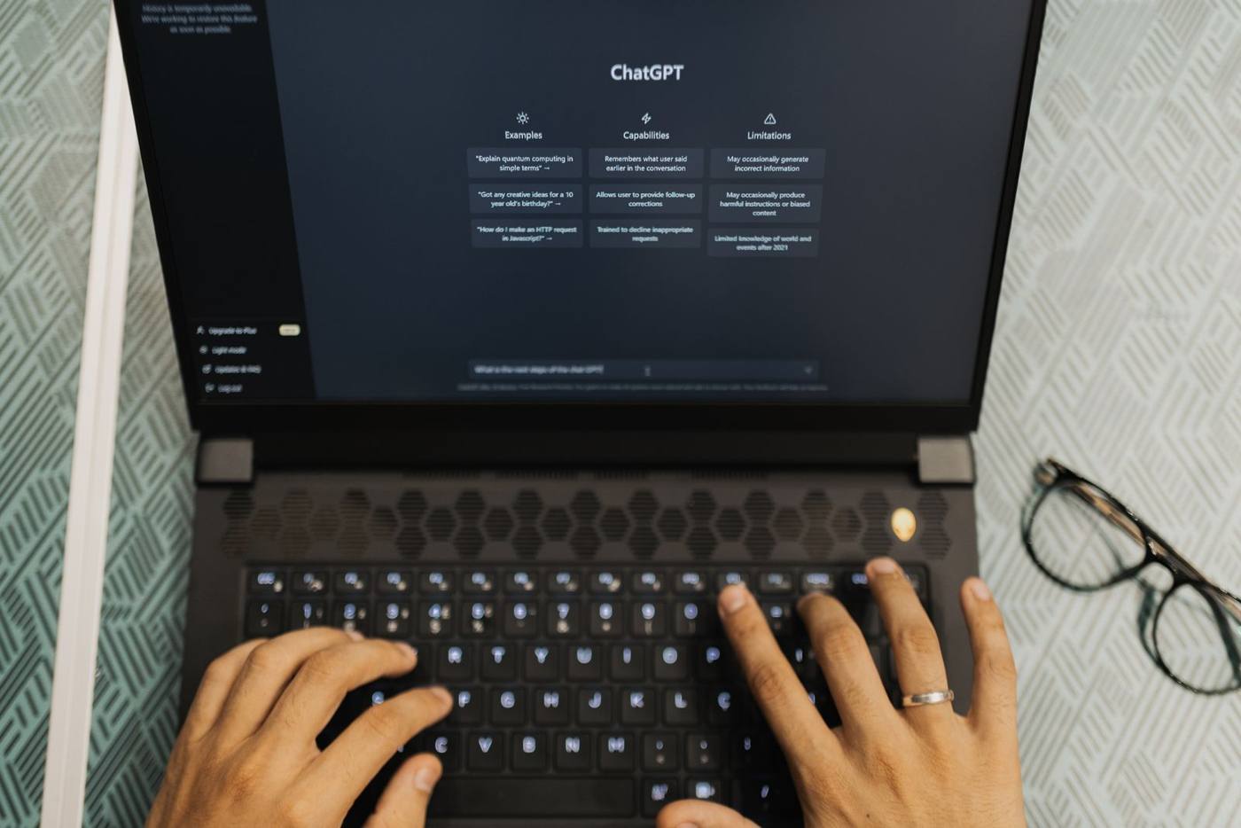 A person using a ChatGPT-style AI search interface on a laptop screen.