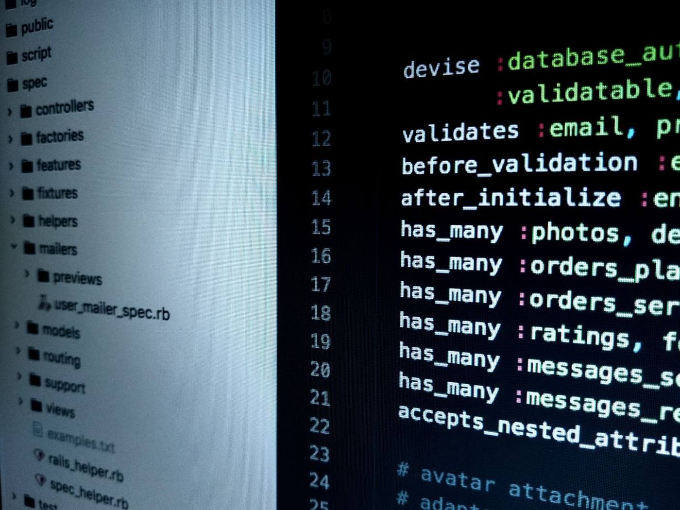 A code editor across multiple monitors, in a development office in Bucharest.