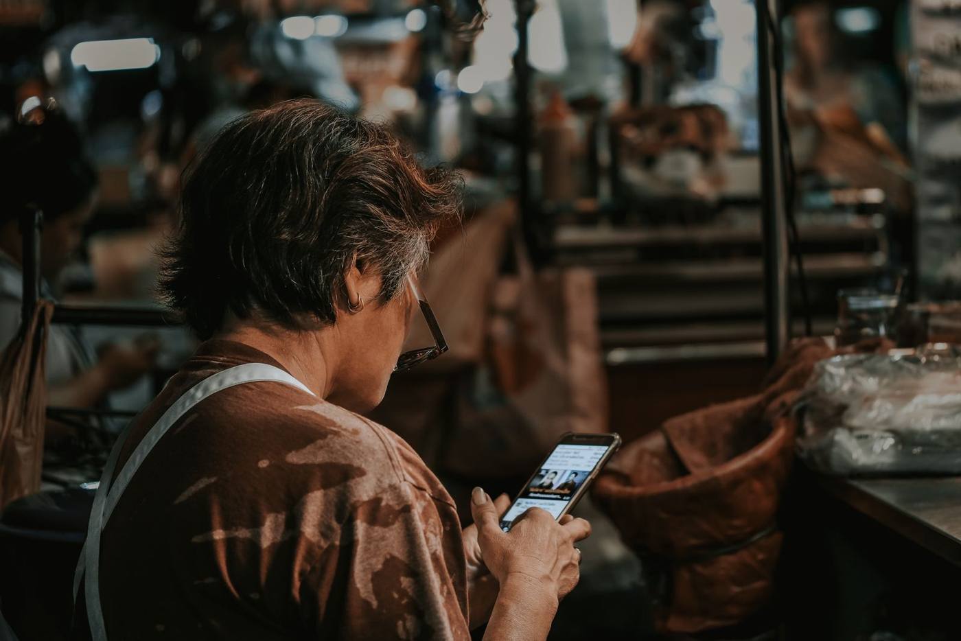 A local business owner checking their Google Business profile on a phone