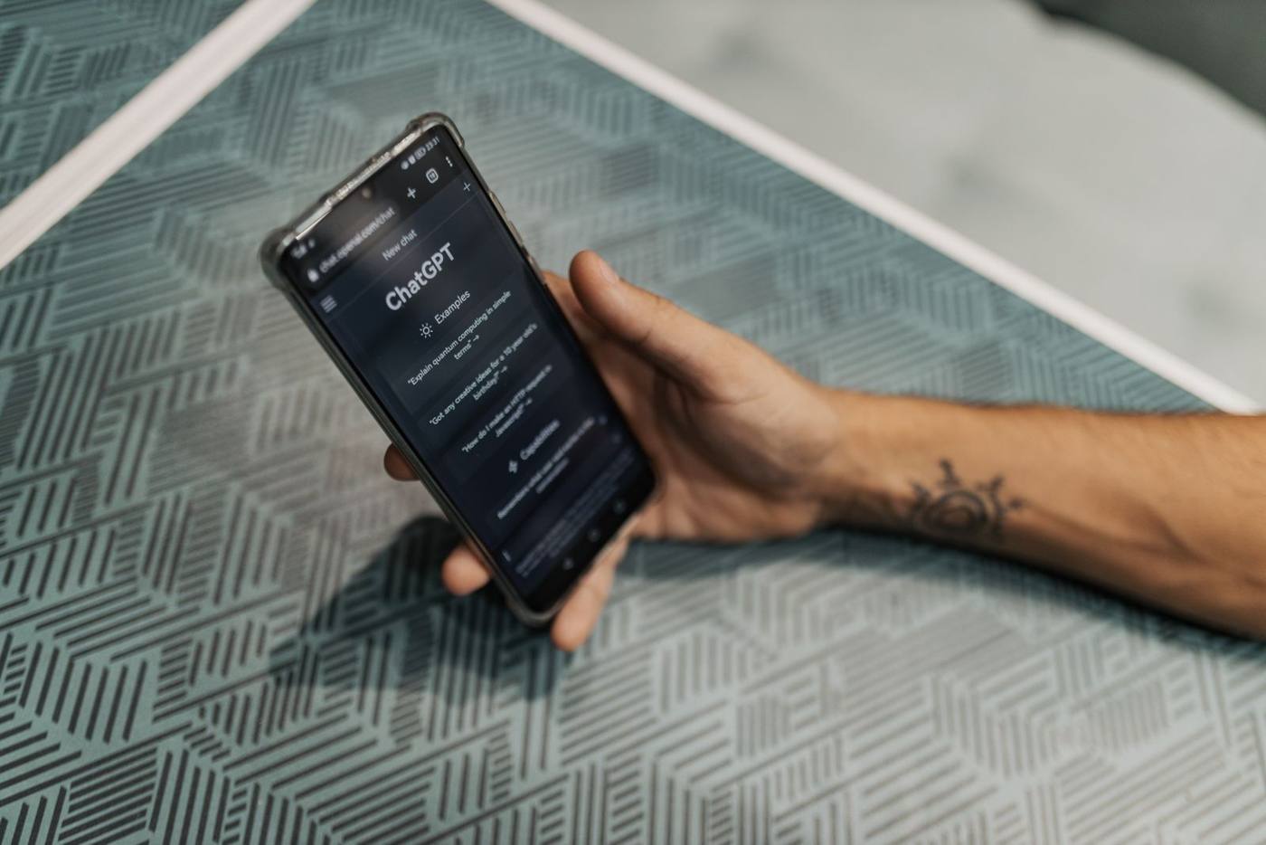 An entrepreneur checks an AI chatbot's answer about suppliers in his field, on his phone