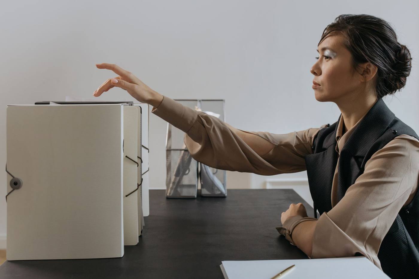 Entrepreneur filling in tax registration documents at a desk, with a laptop open