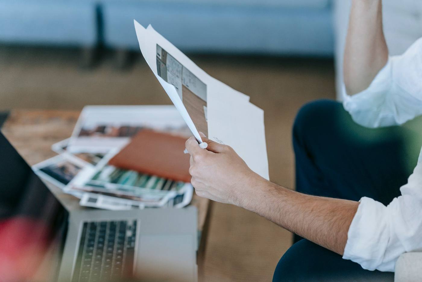 Entrepreneur calculating marketing costs on a laptop, small company office