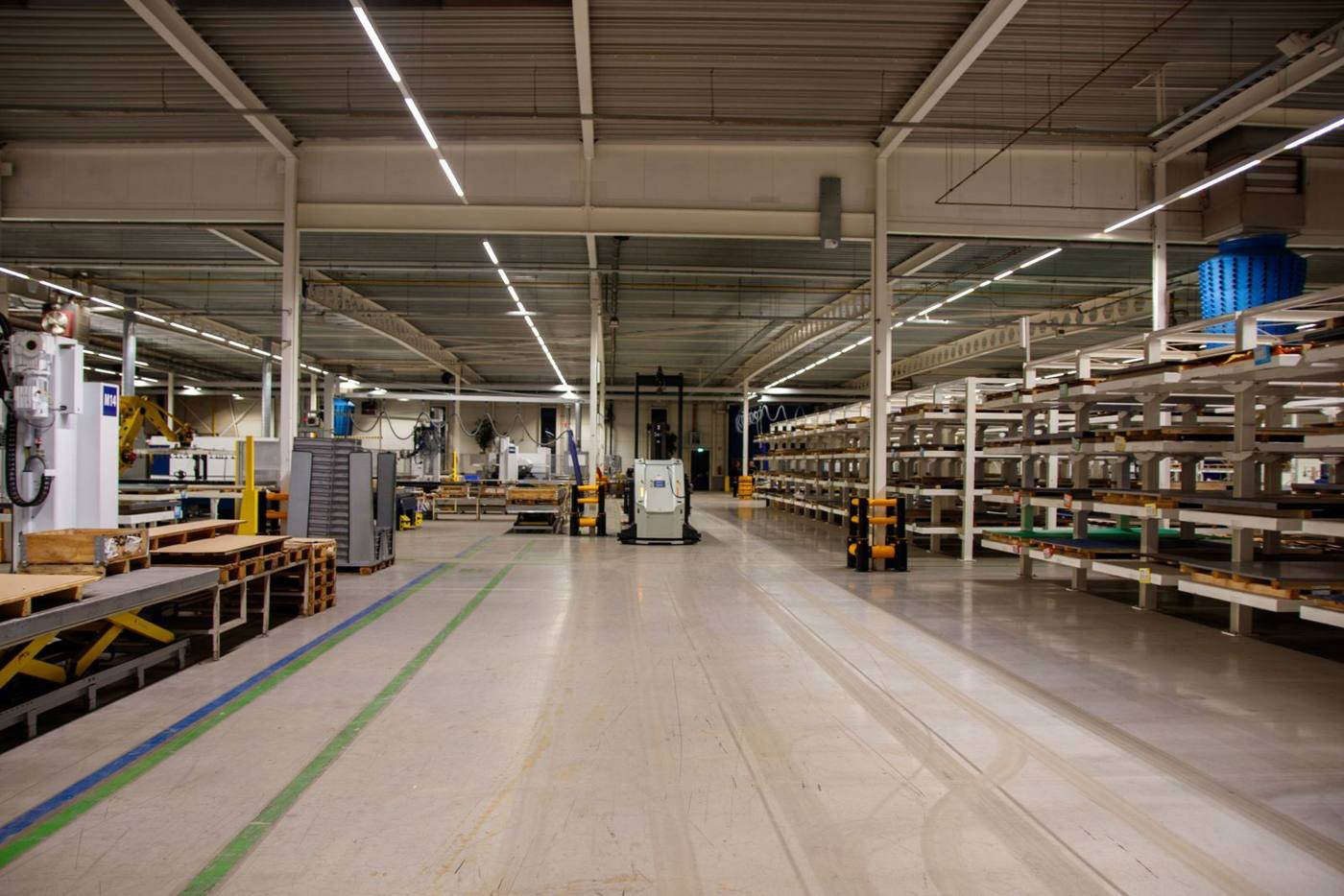 An automated production line in a logistics warehouse, with equipment in motion.