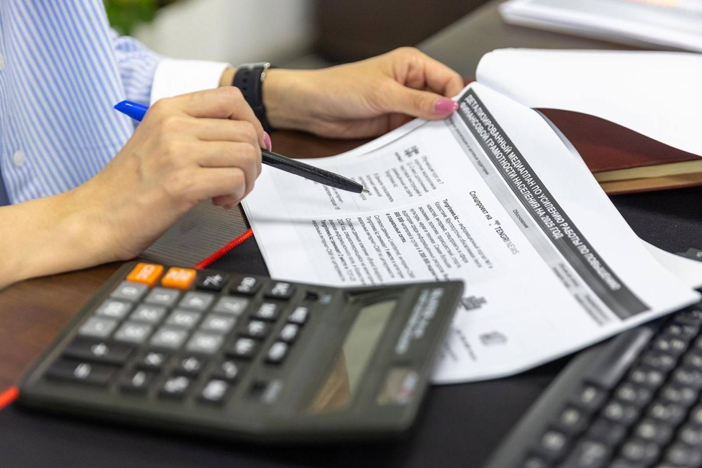 A quote document and calculator on a desk, during a contract review.