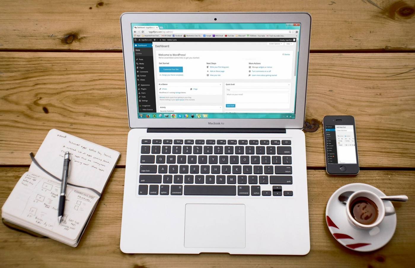 A notebook and open laptop on a desk, set up to plan a blog article.