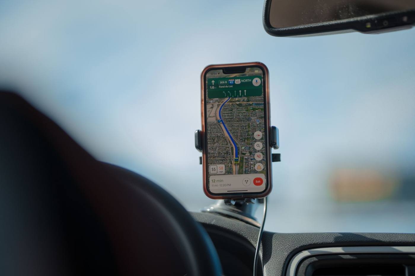 Phone with an open map, mounted on a car dashboard