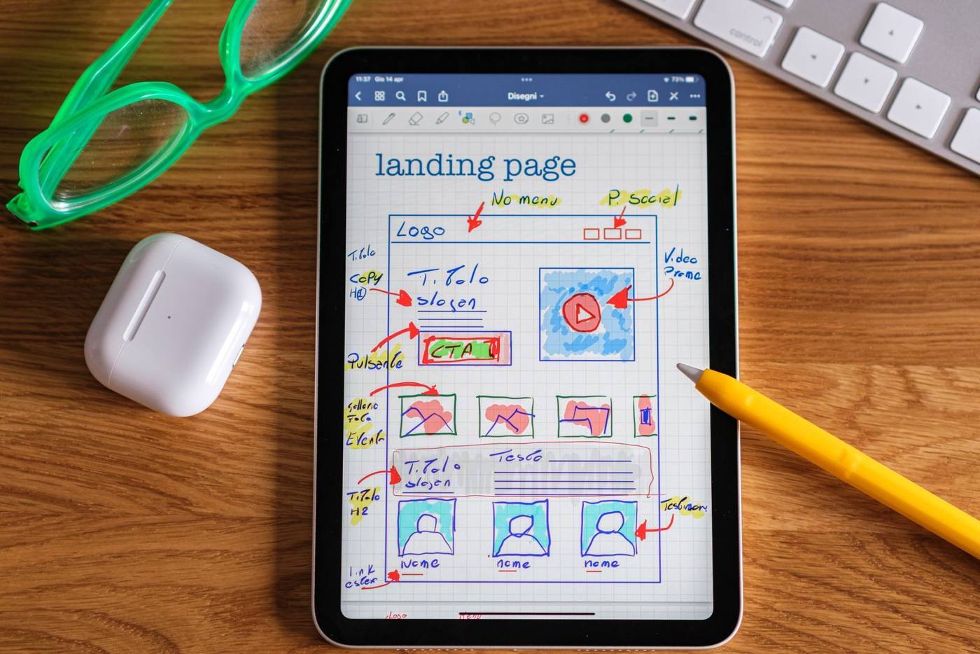 Developer sketching wireframes for a mobile app on a tablet